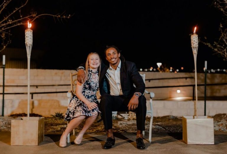 Audrey and Anthony sitting on a bench together.
