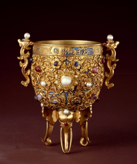 A golden wine cup encrusted with jewels, one of the treasures from China's Qing Dynasty on display at the Palace Museum.