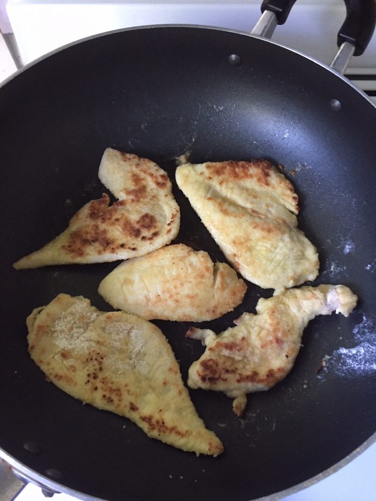 chicken being cooked in wok