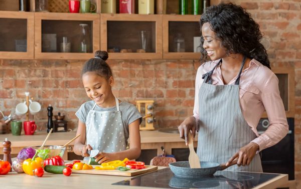 A mother and daughter preparing dinner.