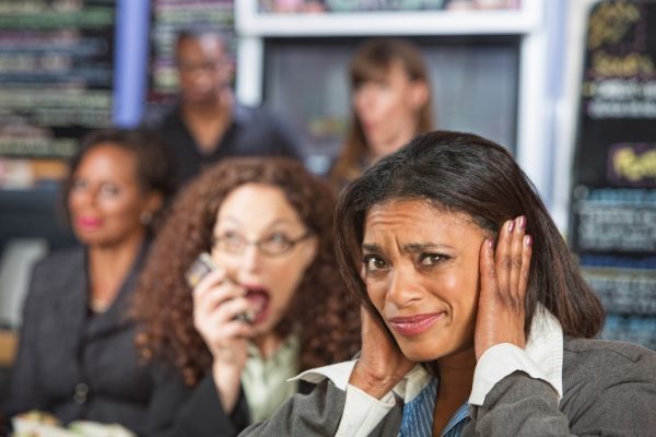 Being loud in a restaurant.