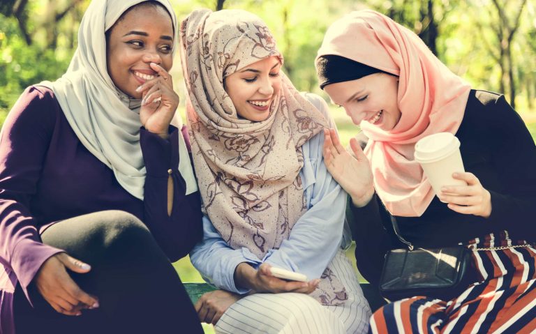 Islamic women laughing.