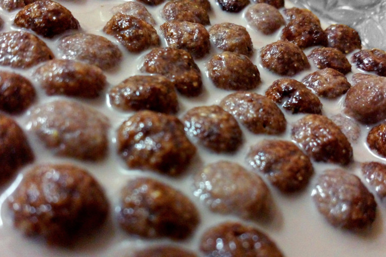 Coco Pops cereal floating in milk.