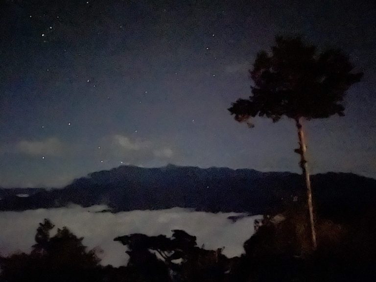 The spectacular view of the star-embellished night sky above the sea of clouds at Ogasawara Mountain.