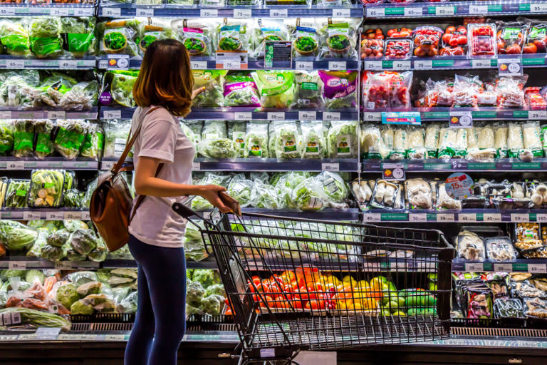 Woman in the grocery store shopping for vegetables.