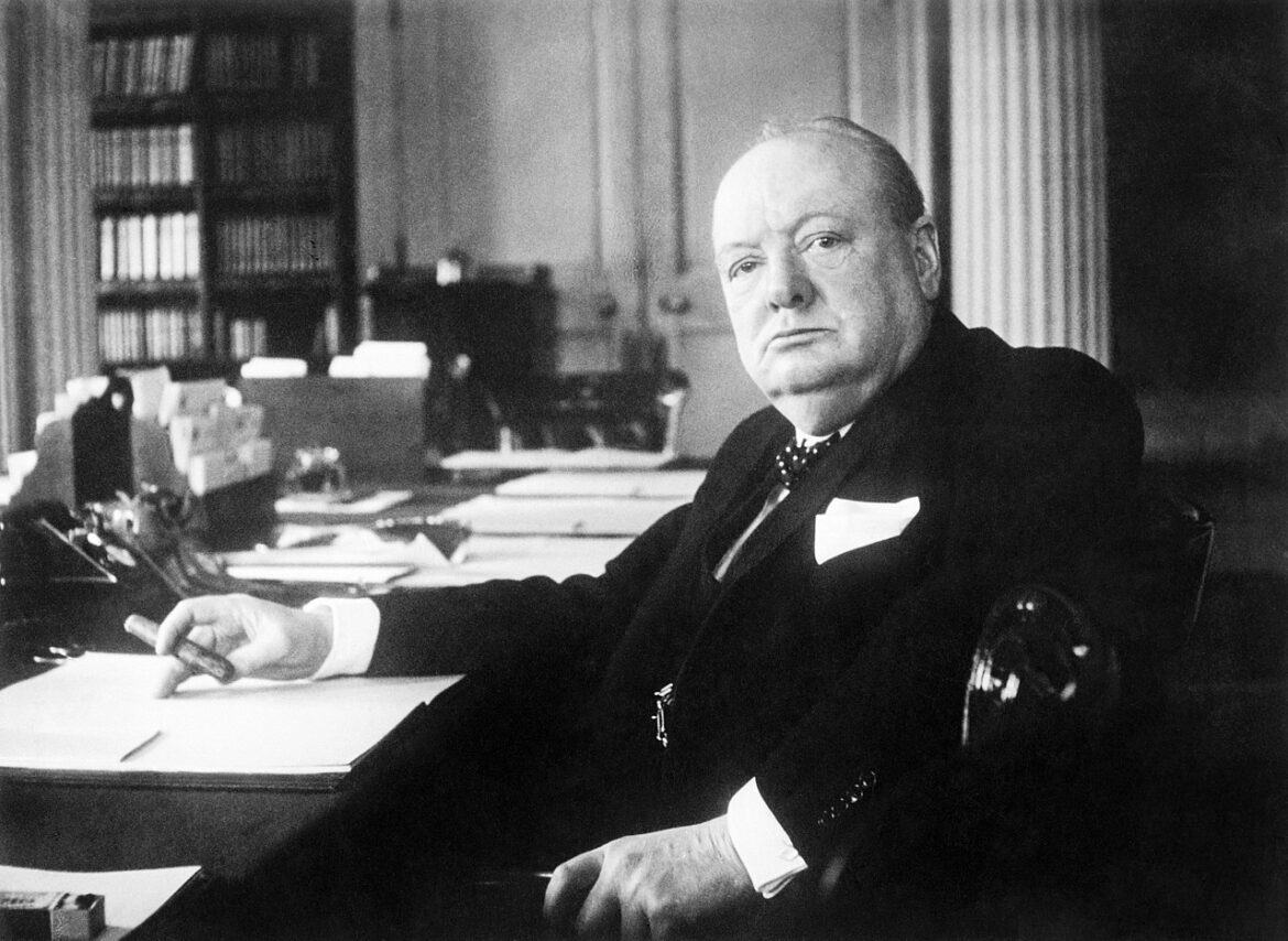 Winston Churchill at his desk.