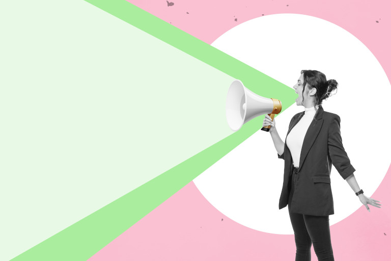 Woman holding a megaphone to speak.