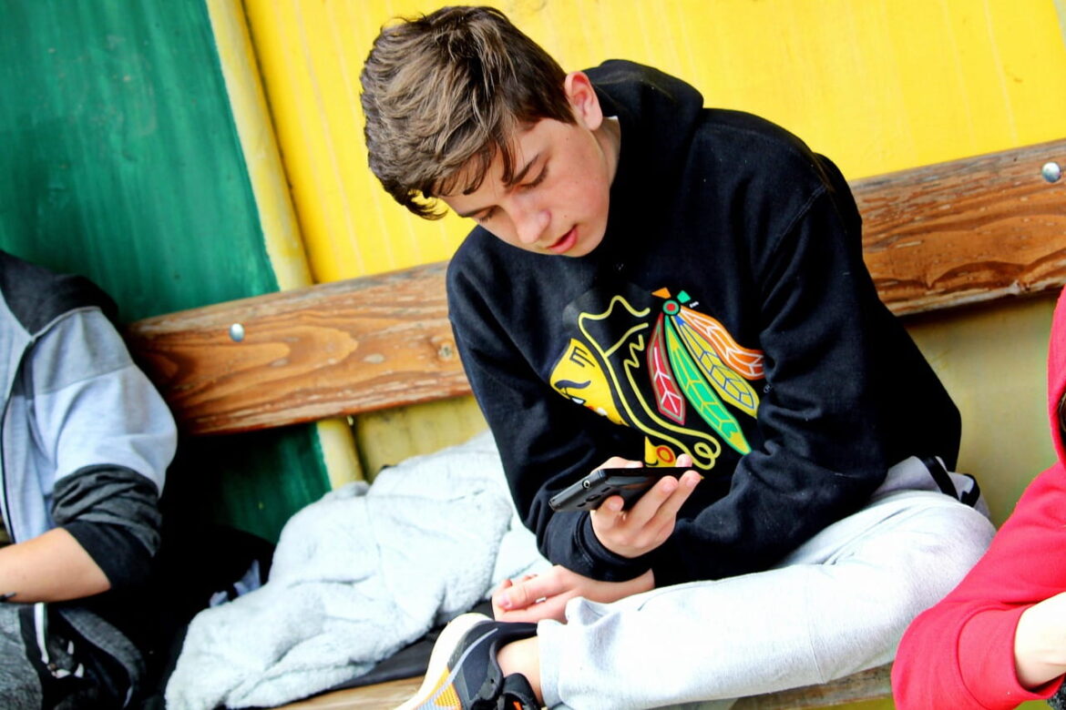 A boy using his smartphone.