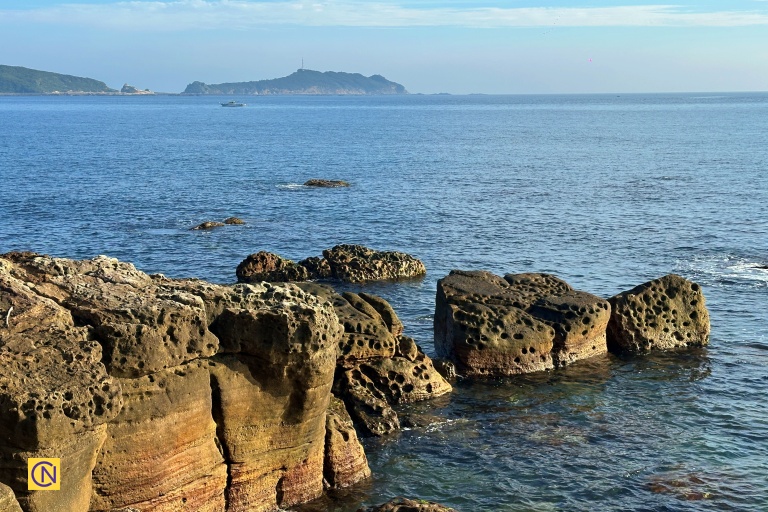 Visitors can admire the striking rock formations that line the seashore.
