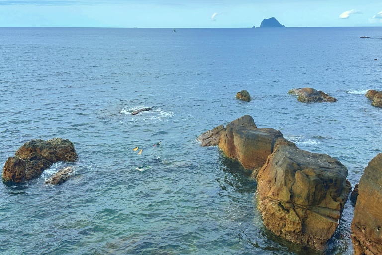 At Wanli Happiness Plaza, visitors might spot snorkelers diving for sea urchins in the crystal-clear coastal waters.
