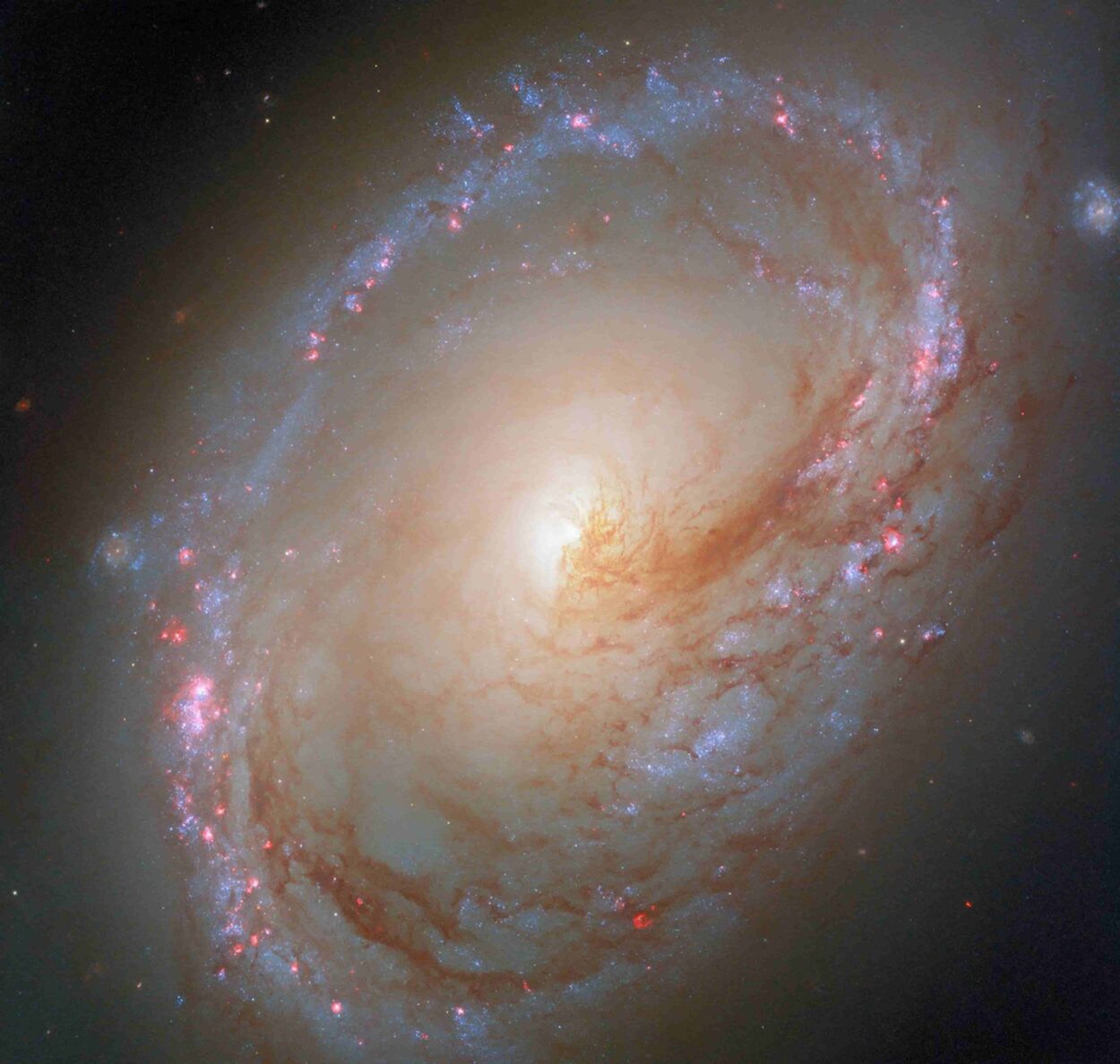 This NASA/ESA Hubble Space Telescope image features the asymmetric spiral galaxy Messier 96.
