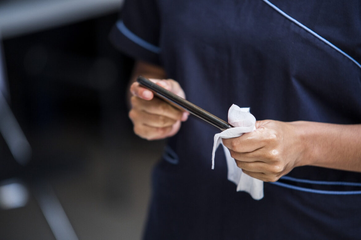 A man cleaning his phone.