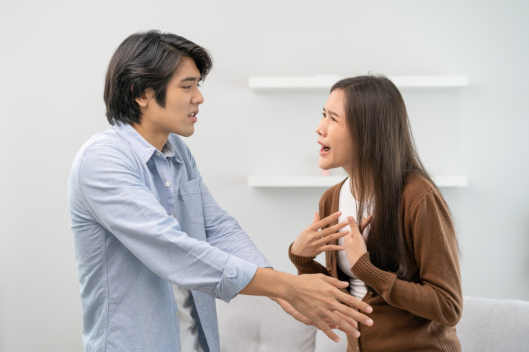 Young Asian couple having an argument at home.