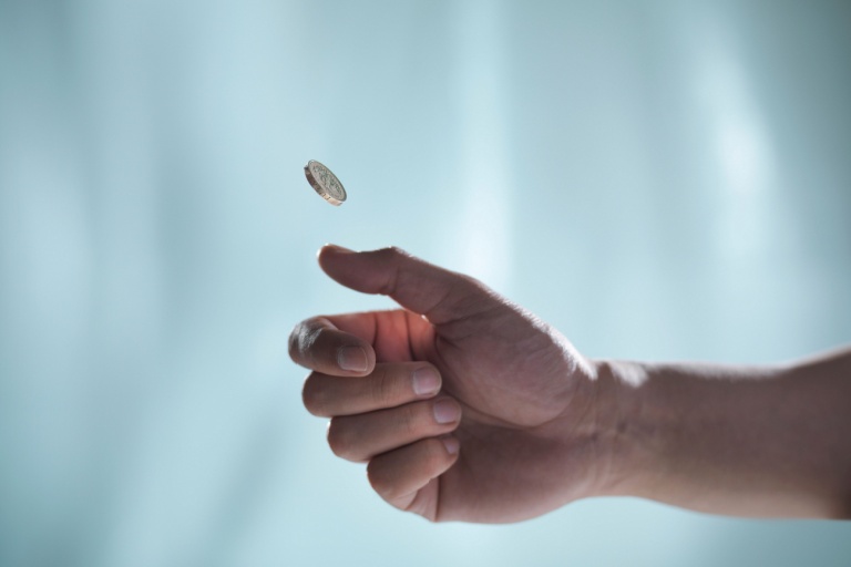 Man flipping a coin.