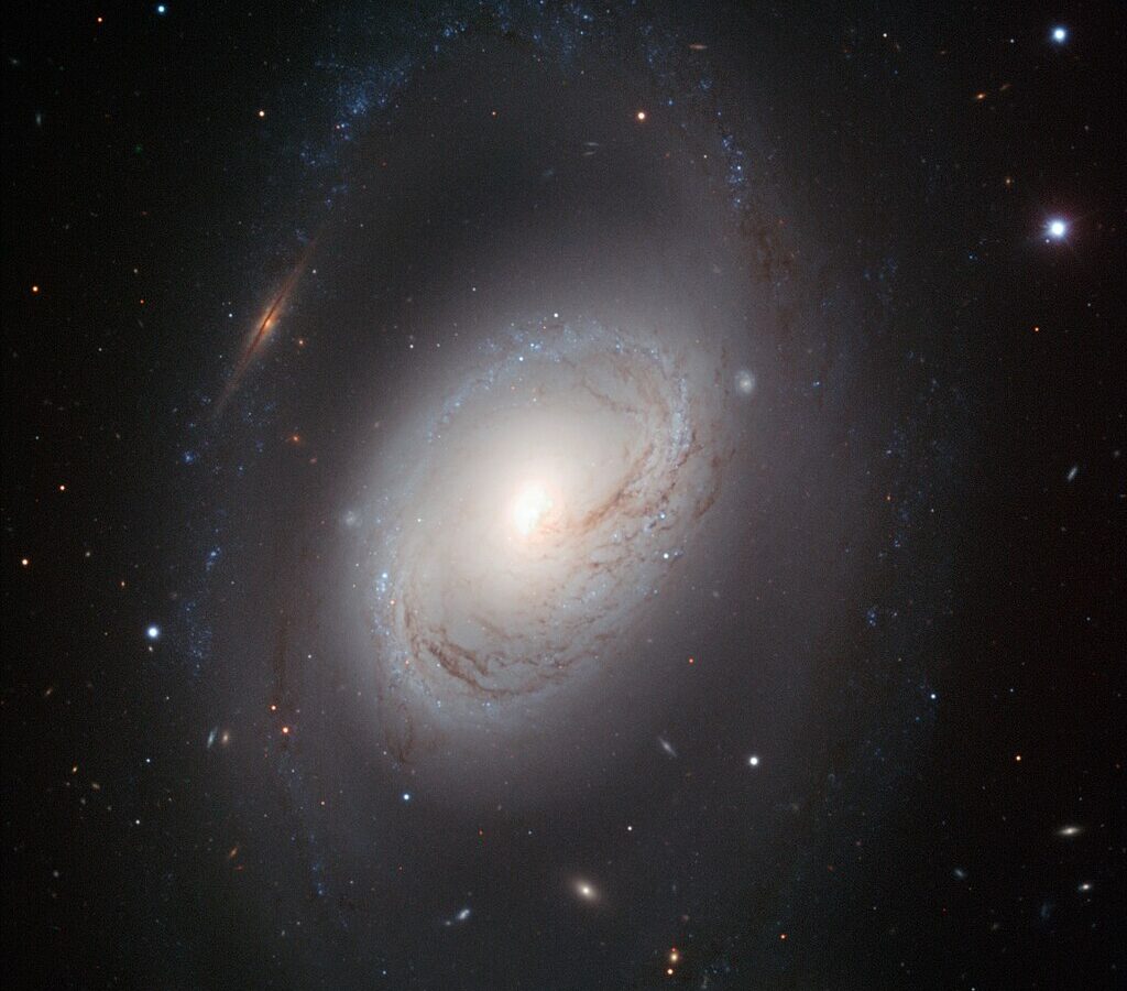 Messier 96 is categorized as a double-barred spiral galaxy with a small inner bulge through the core, along with an outer bulge.