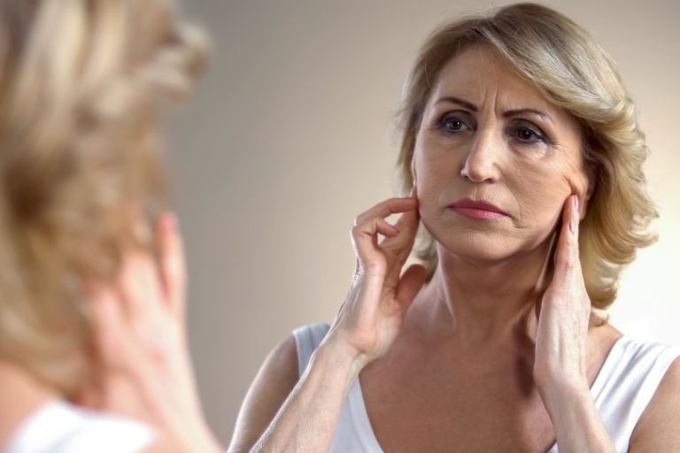 A woman looking in the mirror.