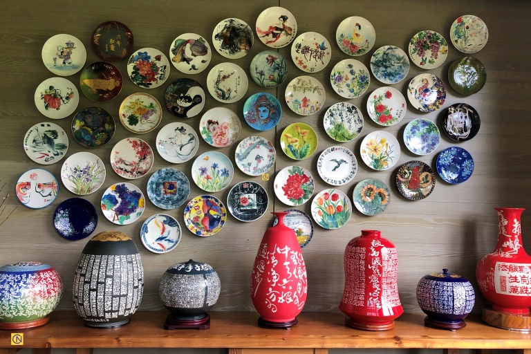 Dozens of artist-designed plates adorn the walls, each bearing its creator’s signature.