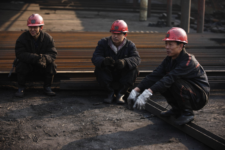 Three Chinese miners on a break.