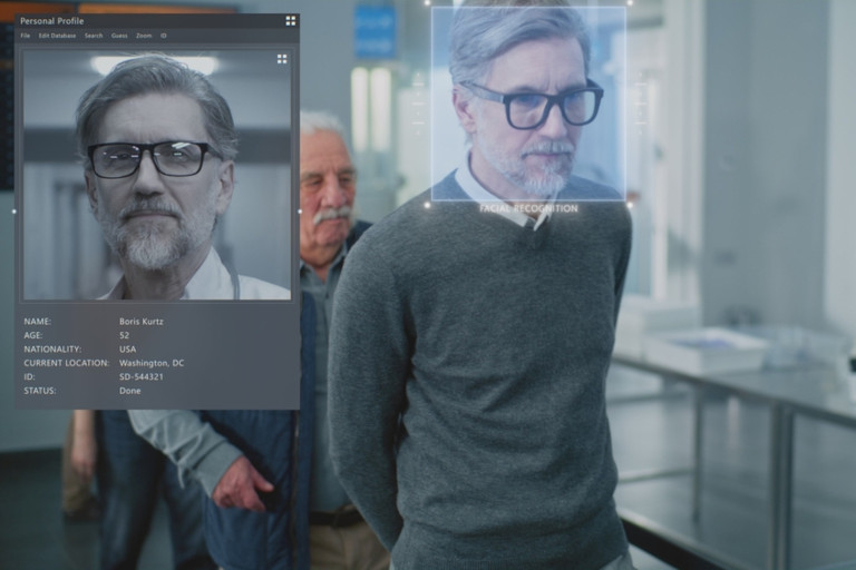 People lined up at a security checkpoint with facial recognition overlay maps and detailed information about them.