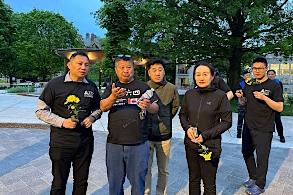 At a memorial marking the 35th anniversary of the Tiananmen Square Massacre, Zhang Yan (second from right) stands with fellow democracy activists in Toronto.