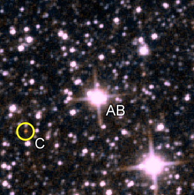 A Wide-field Infrared Survey Explorer (WISE) image of the triple Wolf 1130AB (center) and 1130C (lower left in the yellow circle).