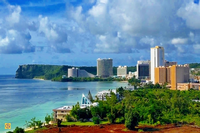 A magnificent panoramic view of Two Lovers Point rising above the stunning blue expanse of Tumon Bay.