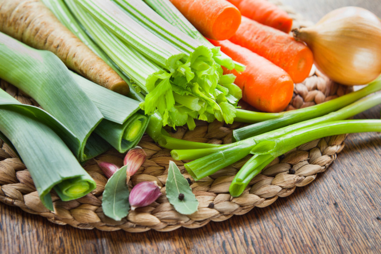 Vegetables for making broth including onions, leeks, carrots, garlic, and parsnips.