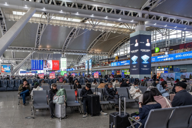 Passengers waiting in the main hall of Guangzhou South Railway Station.