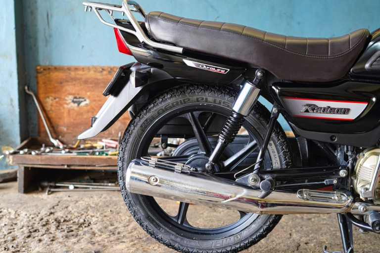 Motorcycle sitting in a repair shop.