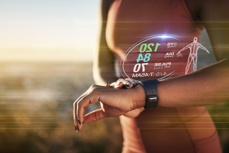 Woman tracking her fitness with a wearable device.