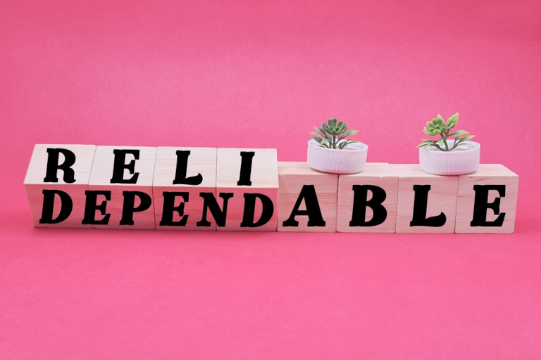 Blocks with the words 'reliable' and 'dependable' on a pink background.