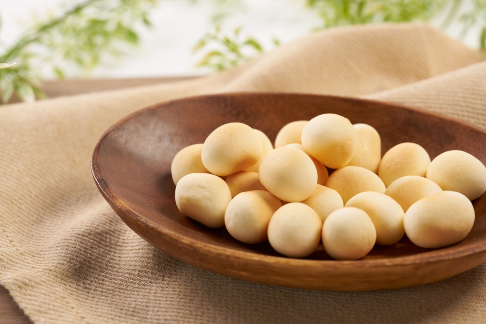 Tamago boro cookies sitting on a wooden dish on a table.