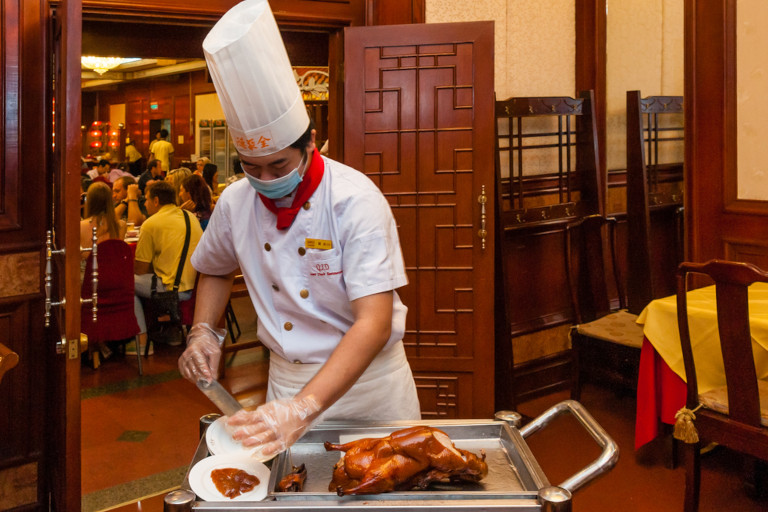 Decades after the 'Four Olds' campaign tried to destroy traditional customs, the intricate art of duck carving remains the centerpiece of the Quanjude experience.