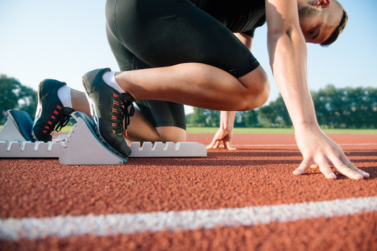 Runner on starting blocks ready for a race.