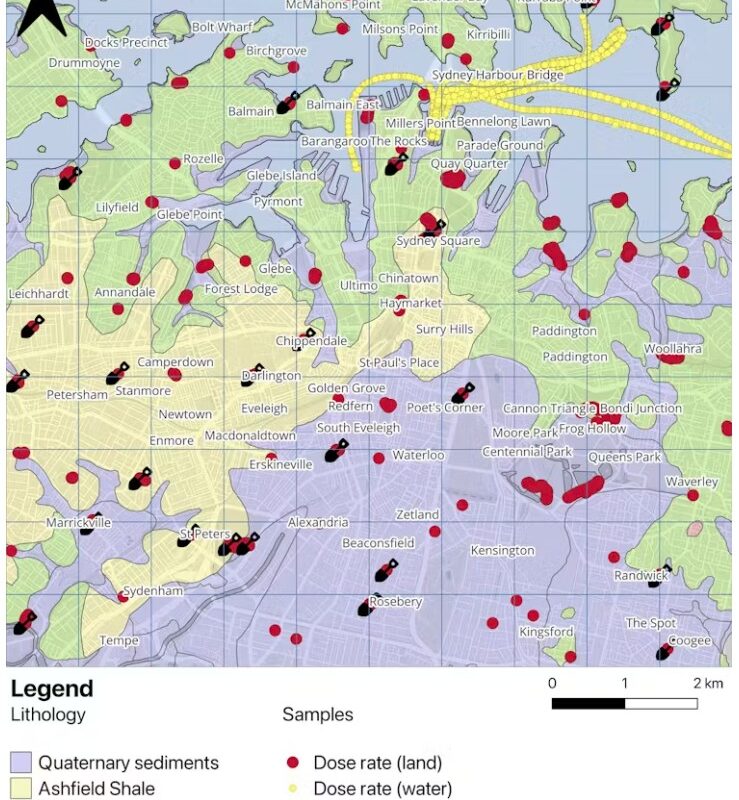 Sampling locations and rock types of the study area in Sydney. The red and yellow circles represent the gamma dose rate measurements on land and water, respectively. The black shovels correspond to the soil sampling locations.