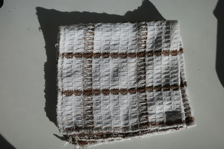 A well-worn tea towel with waffle weave.