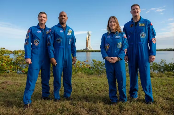 The Artemis II astronauts will travel to space on the giant Space Launch System (SLS) rocket (center).