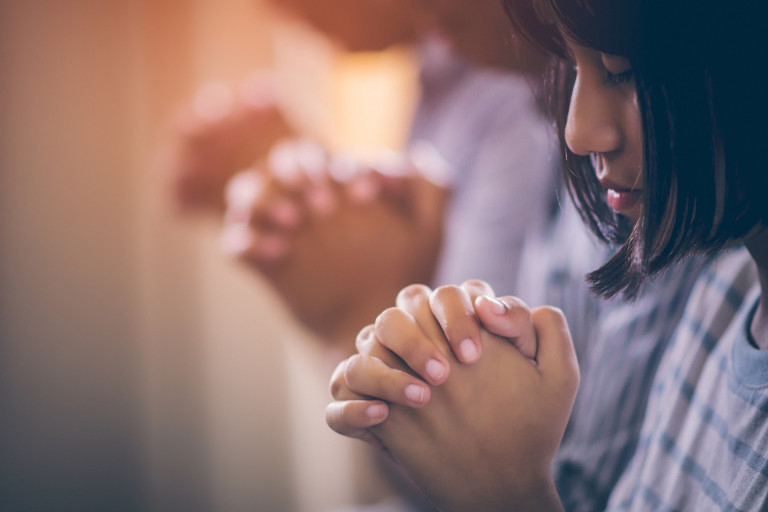 Asian children praying.