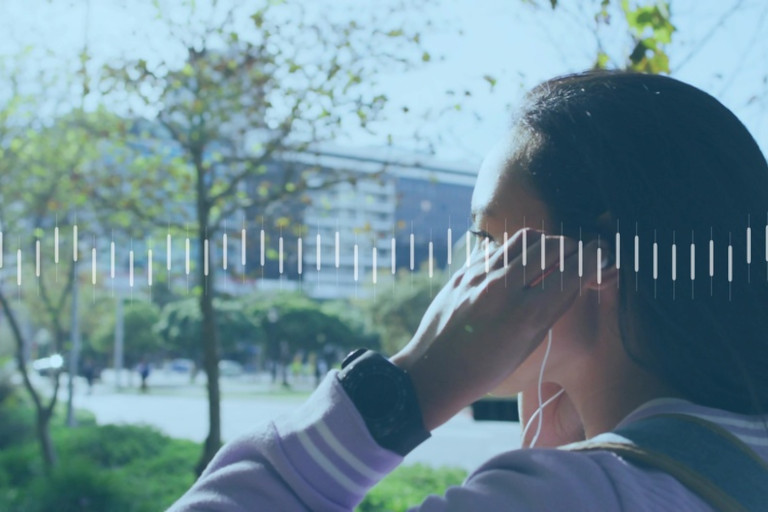 Woman adjusting earbuds outdoors with music waveforms overlaid on the image.