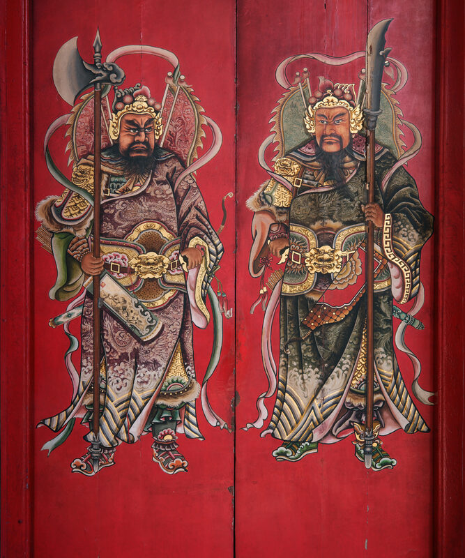 On the eve of the Lunar New Year, a quiet ritual unfolds across China. The old, faded paper comes down. Fresh red couplets go up around the doorframe. And onto the two halves of the front gate, families paste a pair of fierce, armored warriors, swords and iron batons in hand, eyes fixed on the darkness beyond the threshold.
