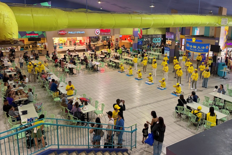 Taiwan Falun Dafa practitioners demonstrate the Falun Gong exercises at Guam Premier Outlets (GPO) food court.