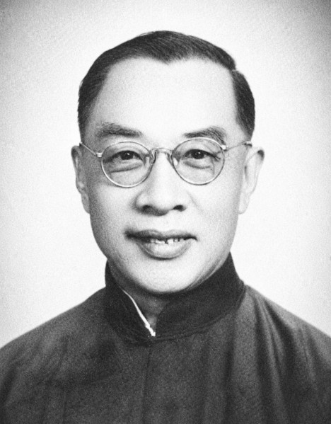 Black-and-white portrait of a Chinese scholar wearing round glasses and a traditional robe.