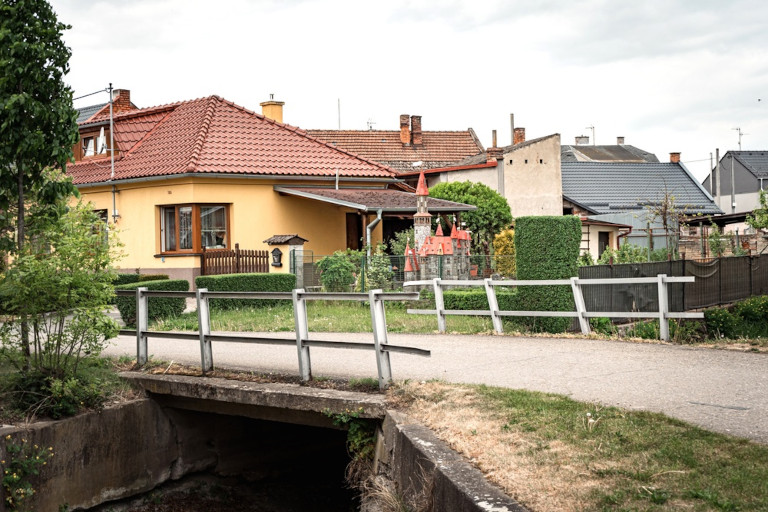 A small bridge on a road in a neighborhood.