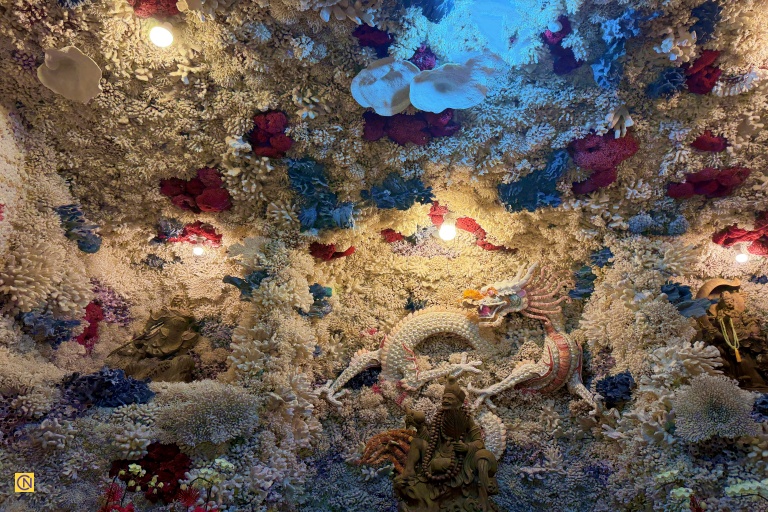 The Coral Shell Temple features the 'Eighteen Arhats Cave,' a tunnel resembling an underwater Dragon Palace.