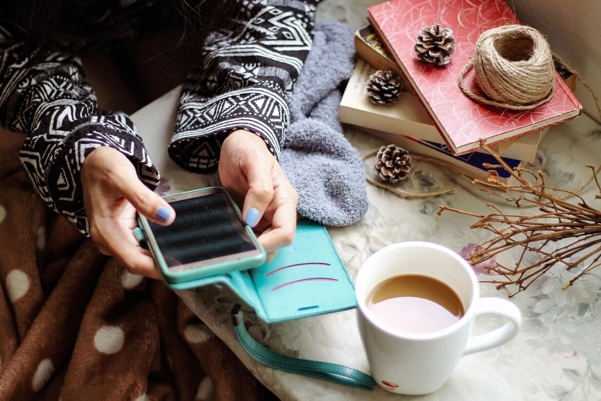 A woman on her phone having a coffee.