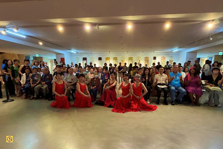 Dancers pose for a group photo with guests attending the opening ceremony of the calligraphy exhibition.