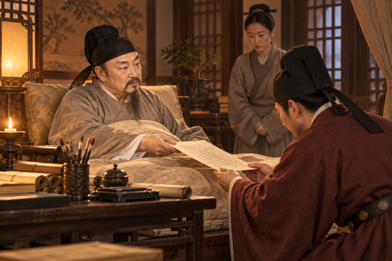 AI-generated image of the gravely ill Fang Xuanling resting in bed as he hands his final memorial to a court official.