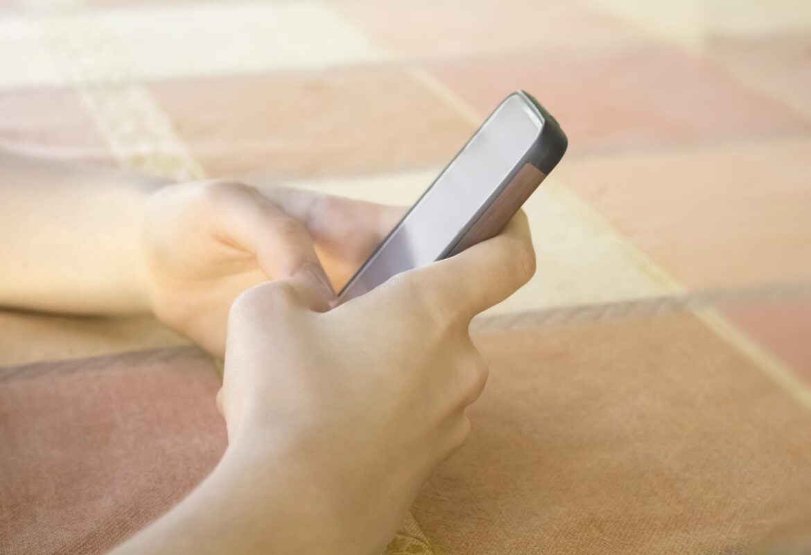 A woman scrolling on her phone.