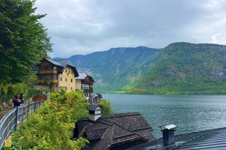 Traditional houses in soft pastel colors line the lakeshore.