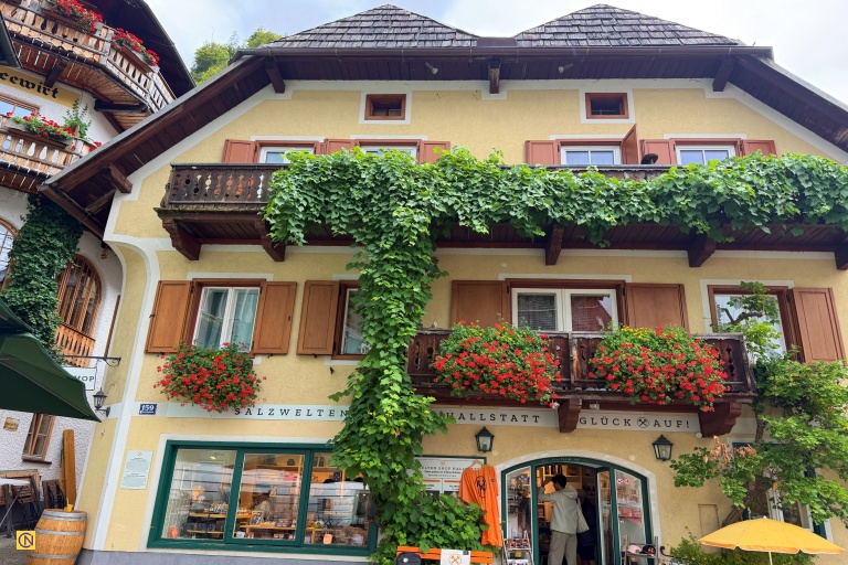 Colorful houses adorned with vibrant flowers add a touch of romance to Hallstatt’s picturesque lakeside village.